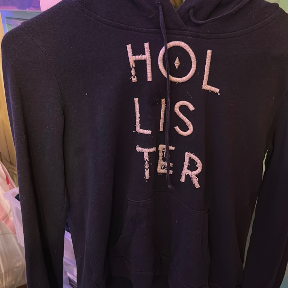 A dark blue Hollister jacket, size small